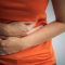 Woman holding abdomen in pain