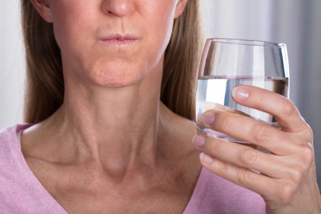 Close-up,Of,Woman,Rinsing,And,Gargling,With,Water,In,Glass